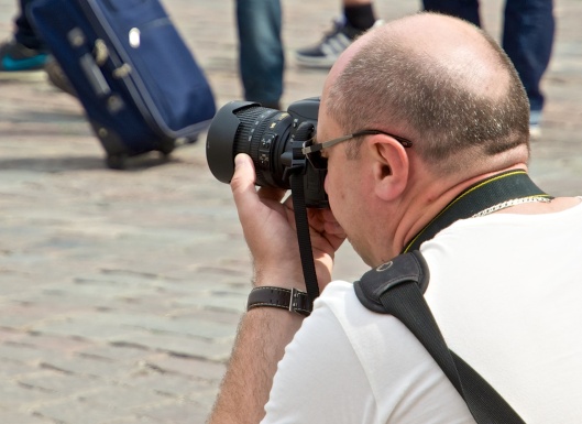A Nikon DSLR with the lenshood mounted backwards